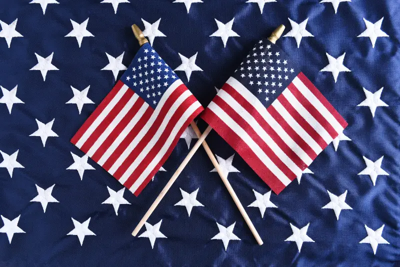 American flag with currency, representing federal legislation moving through Congress