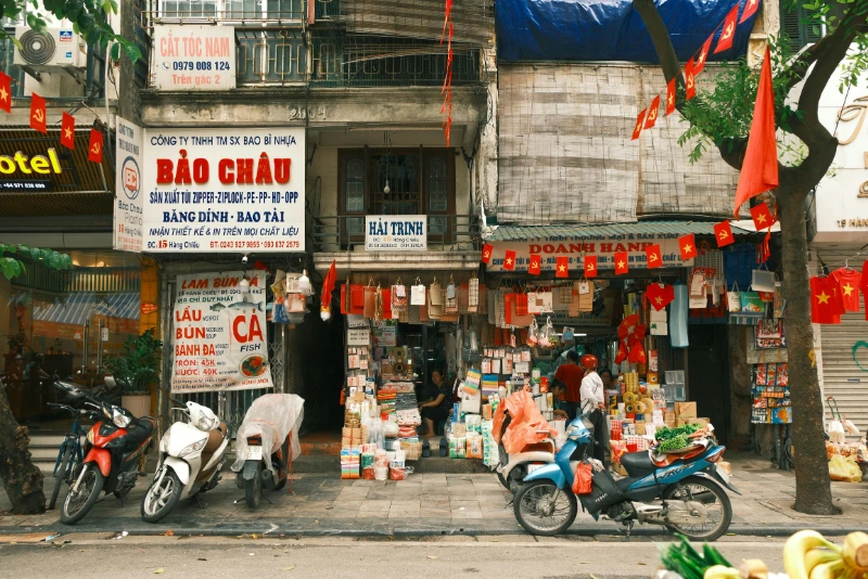 Hanoi, Vietnam street scene with Vietnamese flags